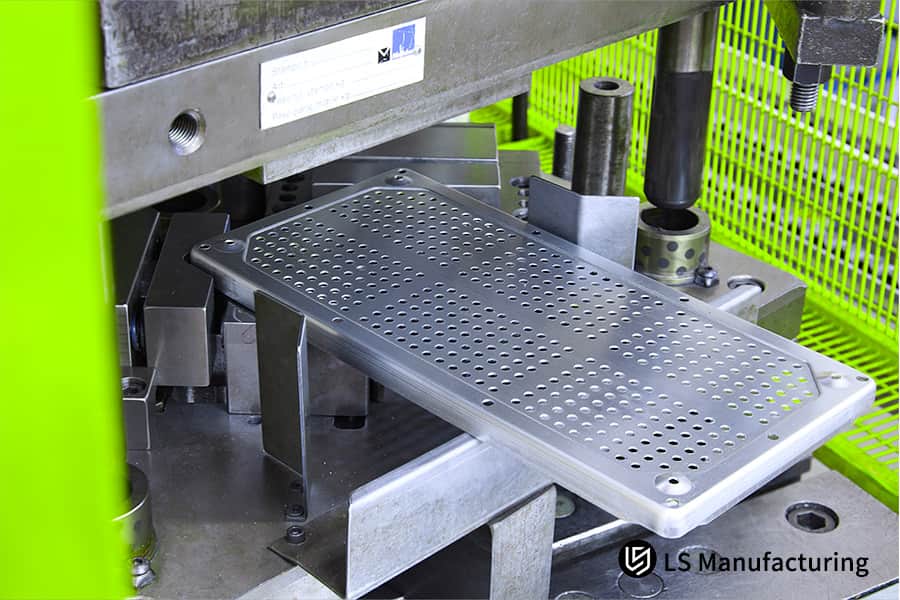 Forming a perforated pattern on galvanized steel sheet for electronic device ventilation or filter panels.