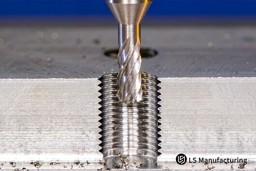 Milling helical grooves on a hardened steel tap for industrial tooling and precision thread cutting applications.