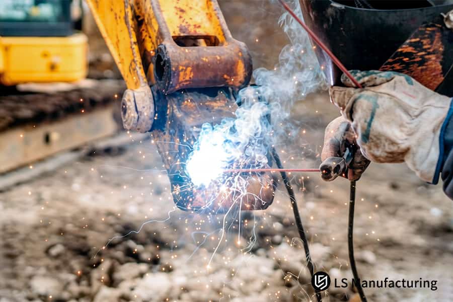 Welding a 6061 aluminum bucket for earthmoving equipment as part of structural metal welding services.