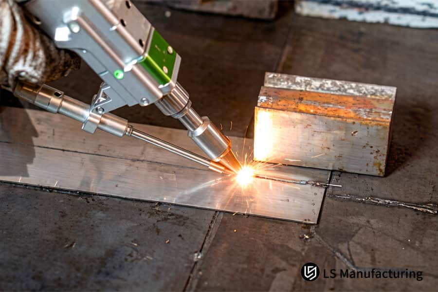 A focused laser beam welds a steel mounting bracket for vehicle suspension or frame structural support.
