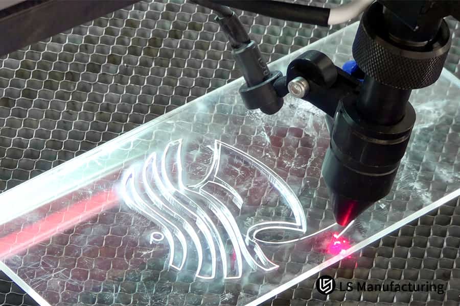 Engraving a decorative fish shape into acrylic for retail signage or artistic installation components.