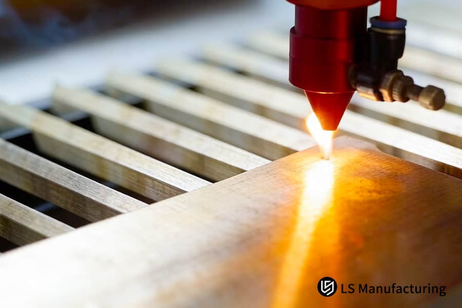 Laser etching burns permanent linear tracks on hardwood for custom cabinetry joinery.