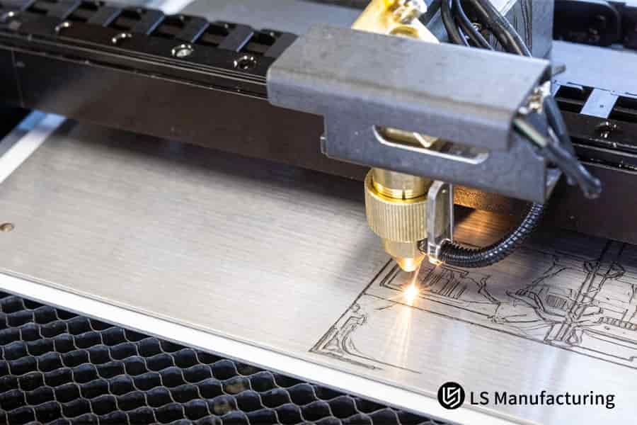 Laser engraving carves precise component edges on stainless steel for precision engineering fixtures.
